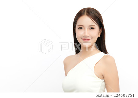A beautiful young Asian woman with clean, fresh skin against a white background. Skincare, facial treatment, cosmetology, beauty, and spa. An elegant portrait of an Asian woman. 124505751