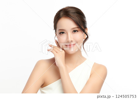A beautiful young Asian woman with clean, fresh skin against a white background. Skincare, facial treatment, cosmetology, beauty, and spa. An elegant portrait of an Asian woman. 124505753