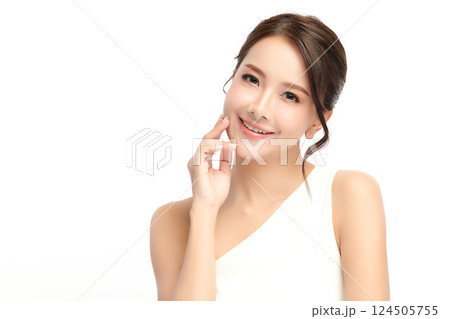A beautiful young Asian woman with clean, fresh skin against a white background. Skincare, facial treatment, cosmetology, beauty, and spa. An elegant portrait of an Asian woman. 124505755