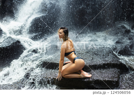 Sexy wet woman under waterfall 124506056