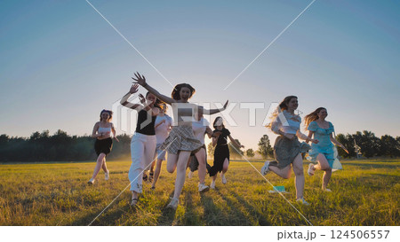 High school students happily running in a field during summer vacation at sunset High school students happily running in a field during summer vacation at sunset 124506557