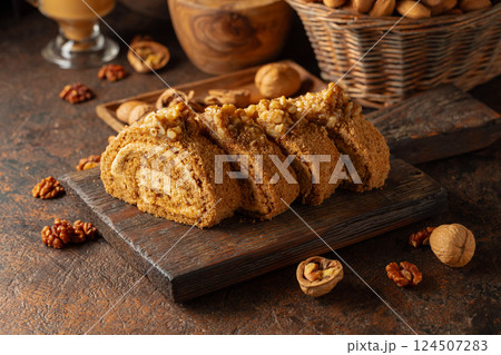 Walnut and buttercream roll: a traditional Oriental pastry. Walnut and buttercream roll: a traditional Oriental pastry. 124507283