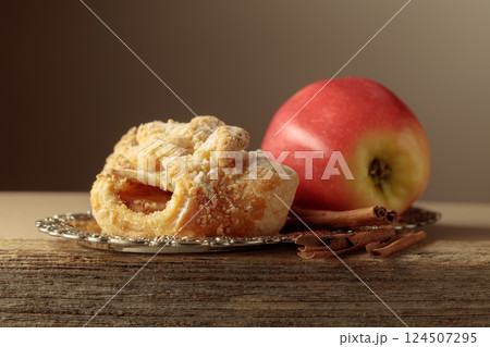 Viennese strudel with apple and cinnamon on old wooden table. 124507295