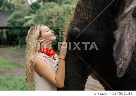 beautiful girl with smiling elephant, elephant village, bali 124508137
