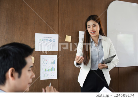 Engagement and Insight. A business professional engaging colleagues with a project presentation. 124509174