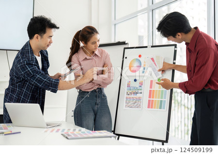 Design Presentation and Feedback. Professionals review and discuss design concepts utilizing colorful visual aids. 124509199