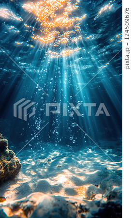 Golden sun rays filter through the ocean, illuminating a vibrant underwater seascape with rising bubbles. 124509676