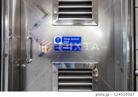 Close Up of Mandatory Safety Notice on Ventilated Industrial Door 124510387