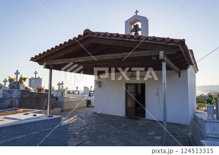 Chapel and crosses in a Greek cemetery at dawn, sunny summer day, Crete 124513315
