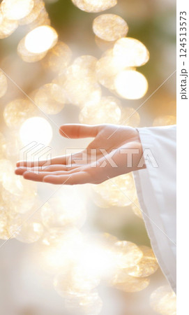 Hand of Jesus reaching out with light in spiritual scene, religious concept background Hand of Jesus reaching out with light in spiritual scene, religious concept background 124513573
