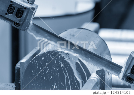 The band saw cutting machine cutting the metal shaft parts with coolant method. The band saw cutting machine cutting the metal shaft parts with coolant method. 124514105
