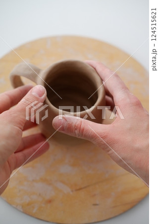 Making pottery from clay, handicraft, clay modeling, master's hands 124515621
