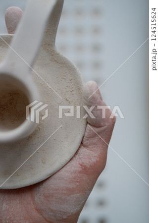 Making pottery from clay, handicraft, clay modeling, master's hands Making pottery from clay, handicraft, clay modeling, master's hands 124515624
