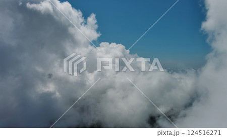 Flying through white fluffy clouds 124516271