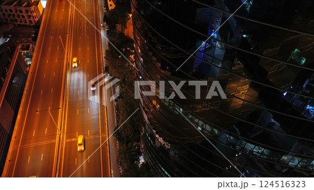 Skycrapper with reflection in glass busy traffic at night 124516323