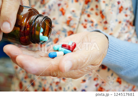 Asian elderly woman holding pill drug in hand, strong healthy medical. Asian elderly woman holding pill drug in hand, strong healthy medical. 124517681