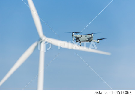 Engineer using drone technology device to survey service maintenance wind turbine power station Engineer using drone technology device to survey service maintenance wind turbine power station 124518067