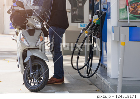 Japanese people filling motorcycle fuel at gas station energy expensive cost in Kyoto Japan Japanese people filling motorcycle fuel at gas station energy expensive cost in Kyoto Japan 124518171