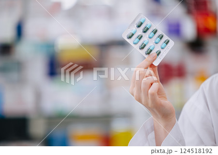 Pharmacist Holding Capsule Medicine Pack With Copy Space For Drug Detail Advertising Text In Pharmacy Drugstore. Pharmacist Holding Capsule Medicine Pack With Copy Space For Drug Detail Advertising Text In Pharmacy Drugstore. 124518192