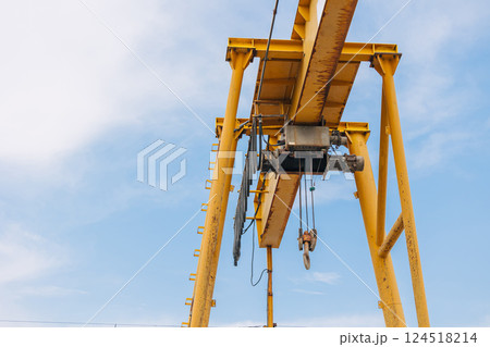 Overhead Crane beam machine with hoist hook head for lifting heavy duty, Construction machine arm in the sky. 124518214