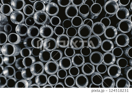 Stainless Steel threaded Pipes. SS threaded Pipes. Metal gas pipe stack pile in market shelf. 124518231