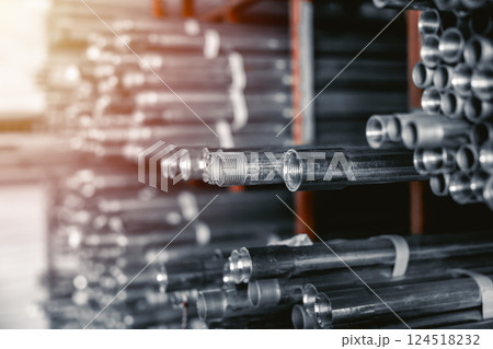 Stainless Steel threaded Pipes. SS threaded Pipes. Metal gas pipe stack pile in market shelf. 124518232