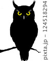 A black owl with yellow eyes 124518294