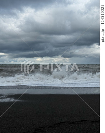 Stormy ocean with crashing waves on a black sand beach 124519325