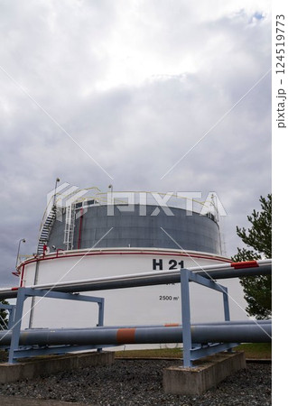 Liquid and fluid gas or oil storage tank, holder, container, dramatic sky background copy space 124519773