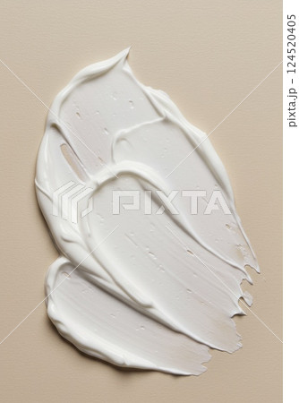 Cream swatch on beige surface in minimal skincare style 124520405