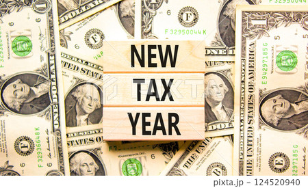 New tax year symbol. Concept words New tax year on beautiful wooden blocks. Dollar bills. Beautiful background from dollar bills. Business new tax year concept. Copy space. New tax year symbol. Concept words New tax year on beautiful wooden blocks. Dollar bills. Beautiful background from dollar bills. Business new tax year concept. Copy space. 124520940