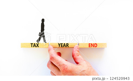 Tax year end symbol. Concept words Tax year end on beautiful wooden blocks. Beautiful white background. Businesswoman icon. Business tax year end concept. Copy space. 124520943