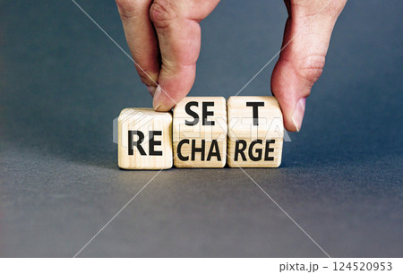 Reset and recharge symbol. Concept words Reset Recharge on beautiful wooden block. Beautiful grey table grey background. Businessman hand. Business reset and recharge concept. Copy space. Reset and recharge symbol. Concept words Reset Recharge on beautiful wooden block. Beautiful grey table grey background. Businessman hand. Business reset and recharge concept. Copy space. 124520953