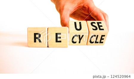 Reuse or recycle symbol. Concept words Reuse Recycle on wooden block. Beautiful white table white background. Businessman hand. Business reuse or recycle concept. Copy space. 124520964