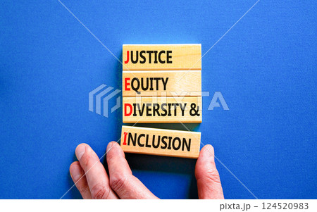 Justice equity diversity inclusion symbol. Concept words JEDI Justice Equity Diversity Inclusion on blocks. Beautiful blue background. Business justice equity diversity inclusion concept. Copy space 124520983