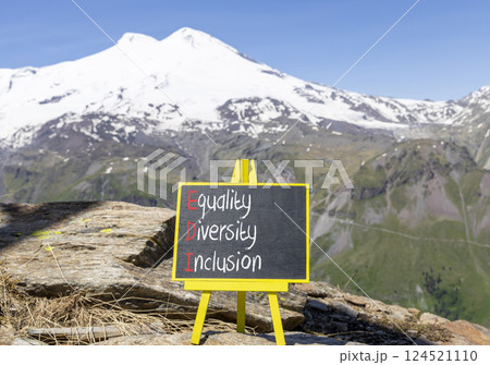 EDI equality diversity inclusion symbol. Concept words EDI equality diversity inclusion on yellow blackboard. Beautiful Elbrus background. Business EDI equality diversity inclusion concept. Copy space 124521110
