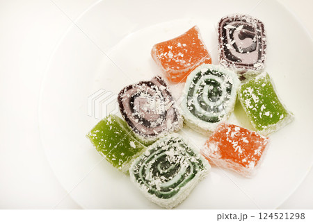 Oriental sweetness. Turkish delight on a white background. Sweets in close-up. Oriental sweetness. Turkish delight on a white background. Sweets in close-up. 124521298