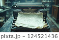 A nostalgic image of a vintage typewriter with worn keys and a crumpled piece of paper with handwritten words. 124521436