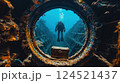 Photograph of a diver exploring a shipwreck looking for a treasure chest and hidden secrets of the deep sea. 124521437
