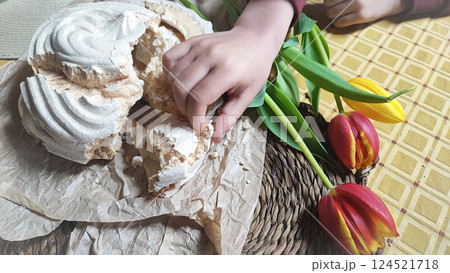 Huge meringue on a decorated rustic table with a backdrop of flowers. Traditional dessert of Aveiro, Portugal, Costa Nova 124521718