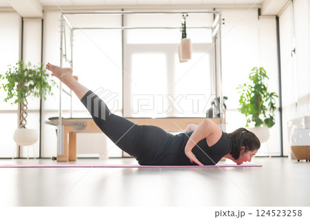 Fat woman doing yoga in studio. Fat woman doing yoga in studio. 124523258