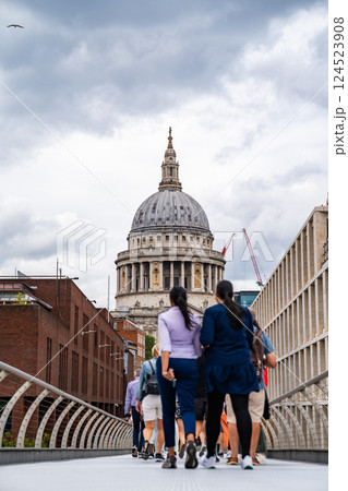 The view of St. Pauls Cathedral from Millennium Bridge is vibrant, with people strolling toward it, blending modern movement with historic architecture. The view of St. Pauls Cathedral from Millennium Bridge is vibrant, with people strolling toward it, blending modern movement with historic architecture. 124523908