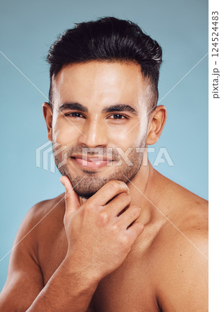 Skincare, beauty and a portrait of man, topless touching beard with healthy skin and natural facial glow and smile on face in India. Male body care, health and model in studio with blue background. 124524483