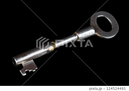 Old rusty key on a black. 124524491