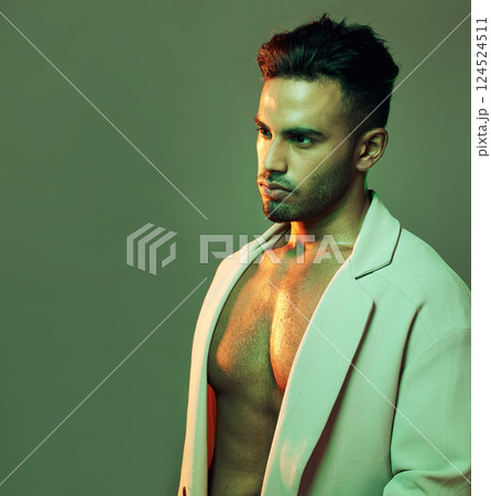 Neon, beauty and fashion with light and man with mockup for glowing, sexy and wellness. Creative, art and designer with young model in green background in studio for gradient, cosmetics and color 124524511
