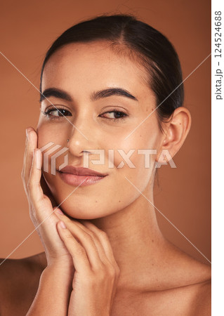 Skincare, beauty and face of Latina woman with smile, healthy and natural skin. Makeup, cosmetics and girl pose with hands for skincare products, spa and wellness isolated on brown background studio Skincare, beauty and face of Latina woman with smile, healthy and natural skin. Makeup, cosmetics and girl pose with hands for skincare products, spa and wellness isolated on brown background studio 124524688