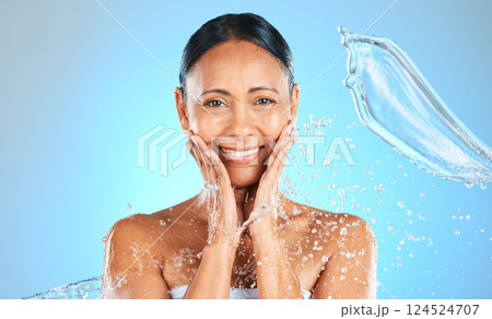 Beauty, splash and water with portrait of woman for skincare, shower and wellness. Hydration, fresh and hygiene with mature face model for luxury, relax and spa against a blue background in studio Beauty, splash and water with portrait of woman for skincare, shower and wellness. Hydration, fresh and hygiene with mature face model for luxury, relax and spa against a blue background in studio 124524707