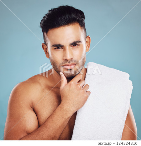 Skincare, health and face of model from India posing for health, wellness and dermatology after cleaning, facial or shaving against blue background. Portrait of beauty man with towel for self care Skincare, health and face of model from India posing for health, wellness and dermatology after cleaning, facial or shaving against blue background. Portrait of beauty man with towel for self care 124524810