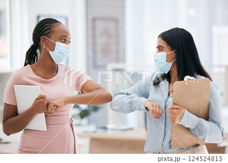 Covid, greeting and teamwork with a business woman and colleague in business working together in their office. Collaboration, diversity and mask with an employee team during the corona virus pandemic Covid, greeting and teamwork with a business woman and colleague in business working together in their office. Collaboration, diversity and mask with an employee team during the corona virus pandemic 124524813