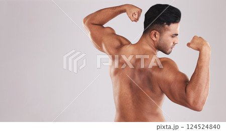 Muscle, strong and man flexing arms with training progress against grey mockup studio background. Fitness, wellness and back of athlete bodybuilder with power and bicep from exercise and workout Muscle, strong and man flexing arms with training progress against grey mockup studio background. Fitness, wellness and back of athlete bodybuilder with power and bicep from exercise and workout 124524840